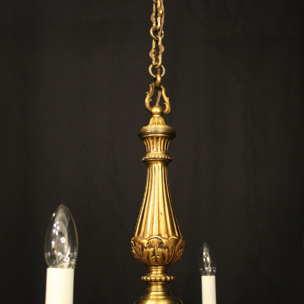 A French six-light chandelier constructed from gilded bronze featuring a fluted central column and scroll-form acanthus arms. View VI