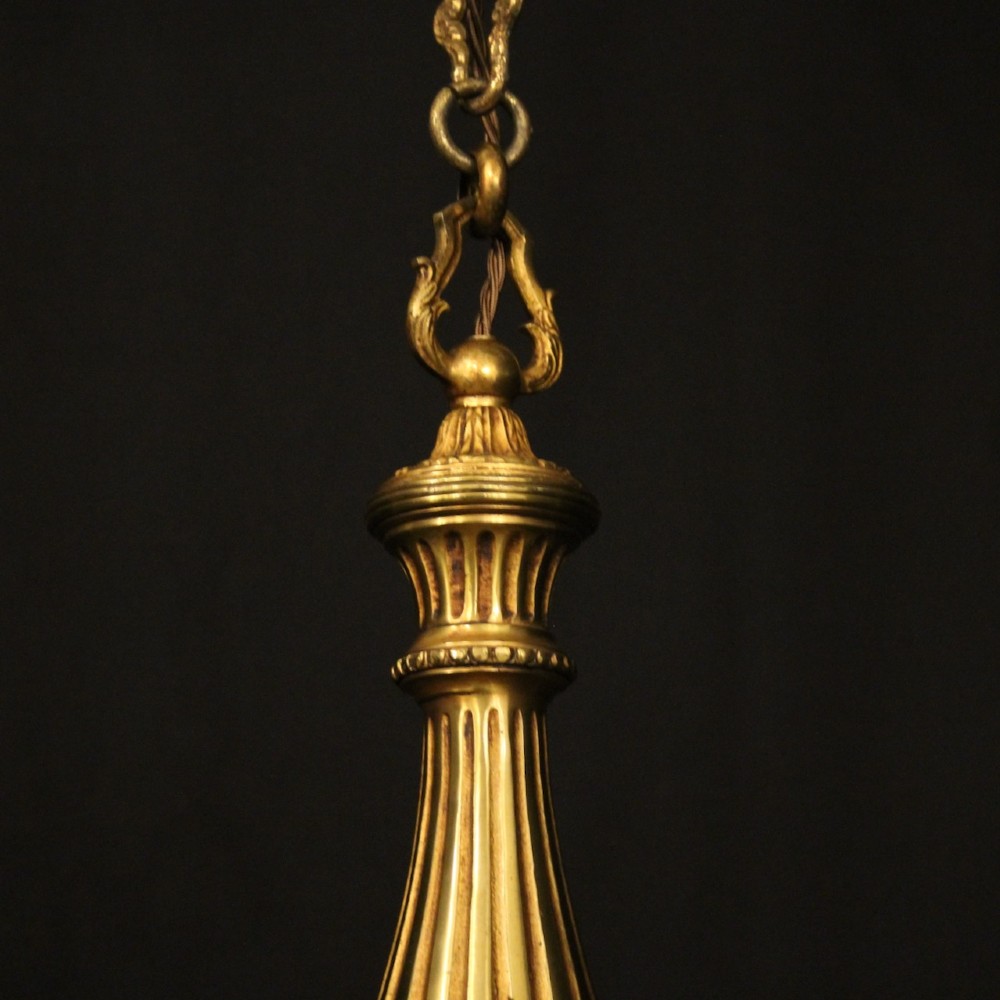 A French six-light chandelier constructed from gilded bronze featuring a fluted central column and scroll-form acanthus arms. View VII