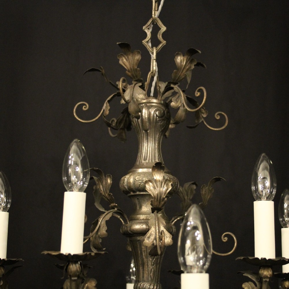 An antique Italian Genoa twelve-light chandelier crafted from gilded metal featuring ornate leaf motifs and scrolling arms supporting candle bulb holders. View VII