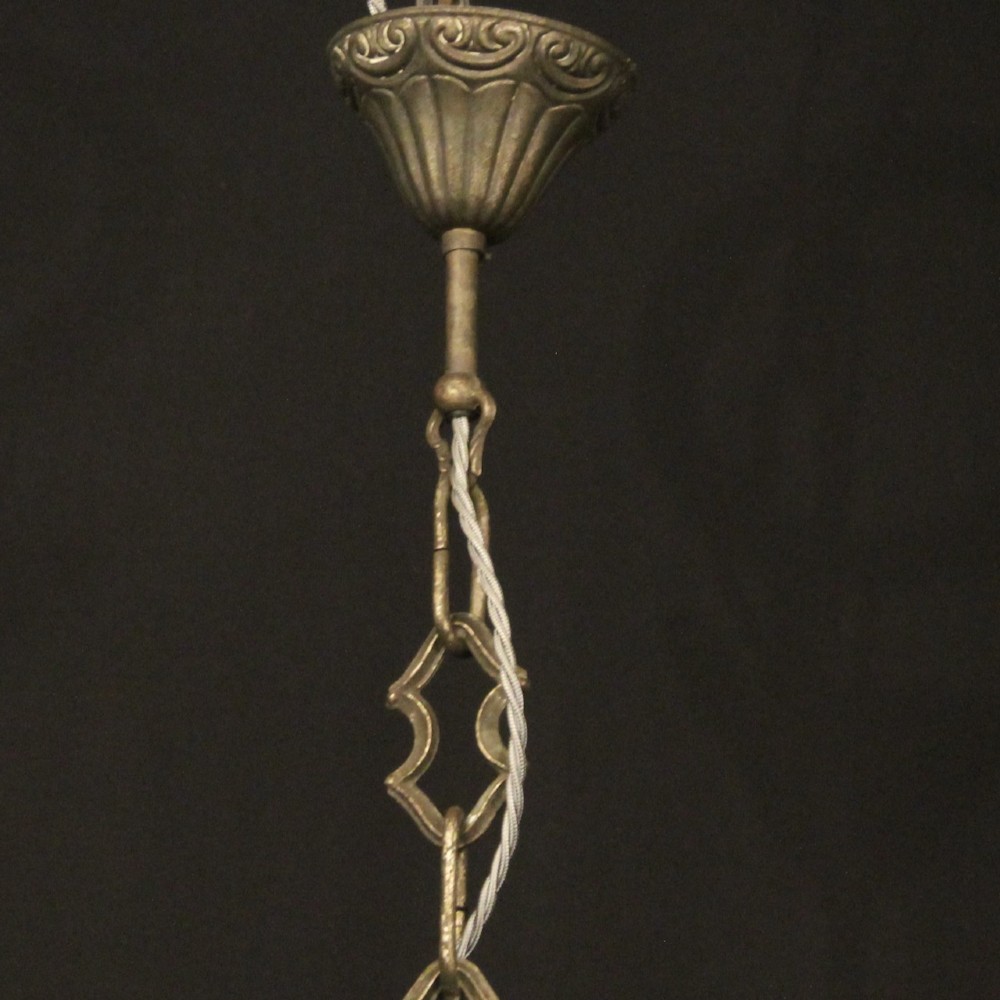 An antique Italian Genoa twelve-light chandelier crafted from gilded metal featuring ornate leaf motifs and scrolling arms supporting candle bulb holders. View X
