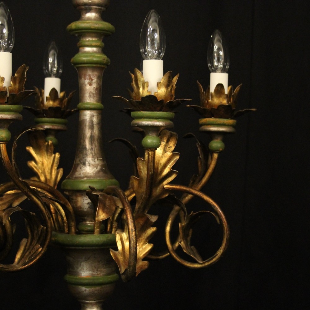 A Florentine six-arm giltwood chandelier featuring hand-carved acanthus leaves, turned central column, green painted accents, and distressed gold leaf finish. View V