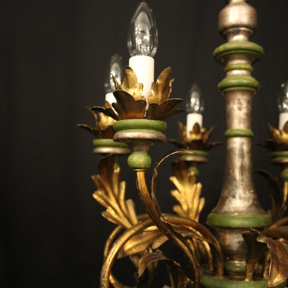A Florentine six-arm giltwood chandelier featuring hand-carved acanthus leaves, turned central column, green painted accents, and distressed gold leaf finish. View VI