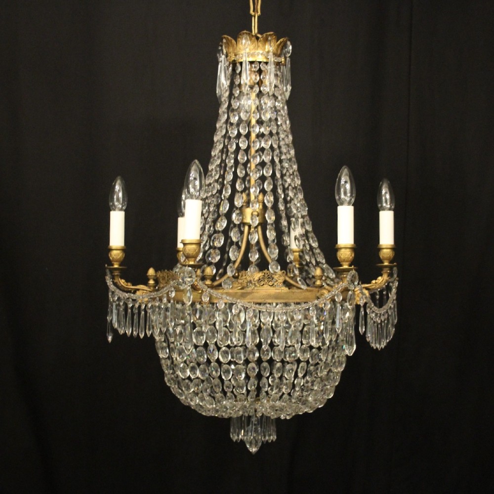 A 19th-century French gilt bronze tent and waterfall chandelier adorned with cascading crystal beads, candle sockets, and hanging glass prisms.