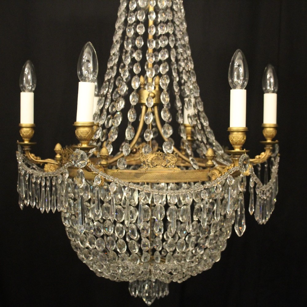 A 19th-century French gilt bronze tent and waterfall chandelier adorned with cascading crystal beads, candle sockets, and hanging glass prisms. View II