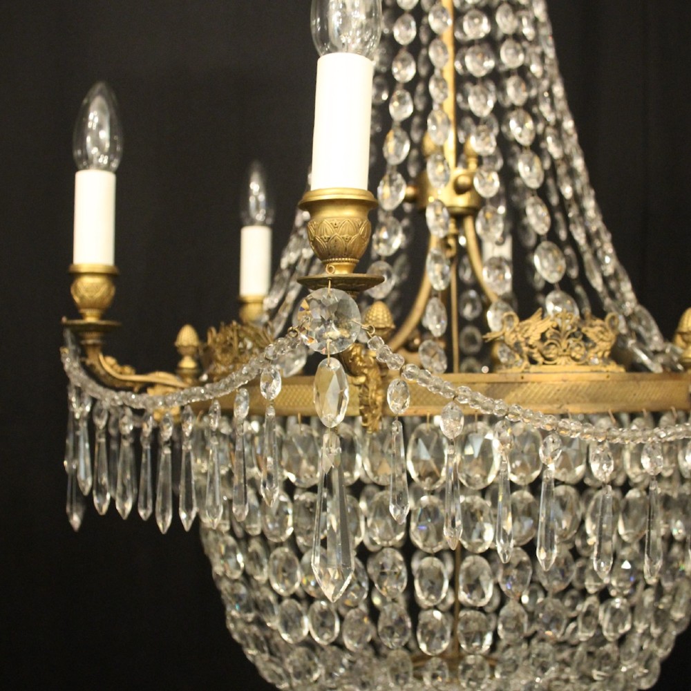 A 19th-century French gilt bronze tent and waterfall chandelier adorned with cascading crystal beads, candle sockets, and hanging glass prisms. View IV
