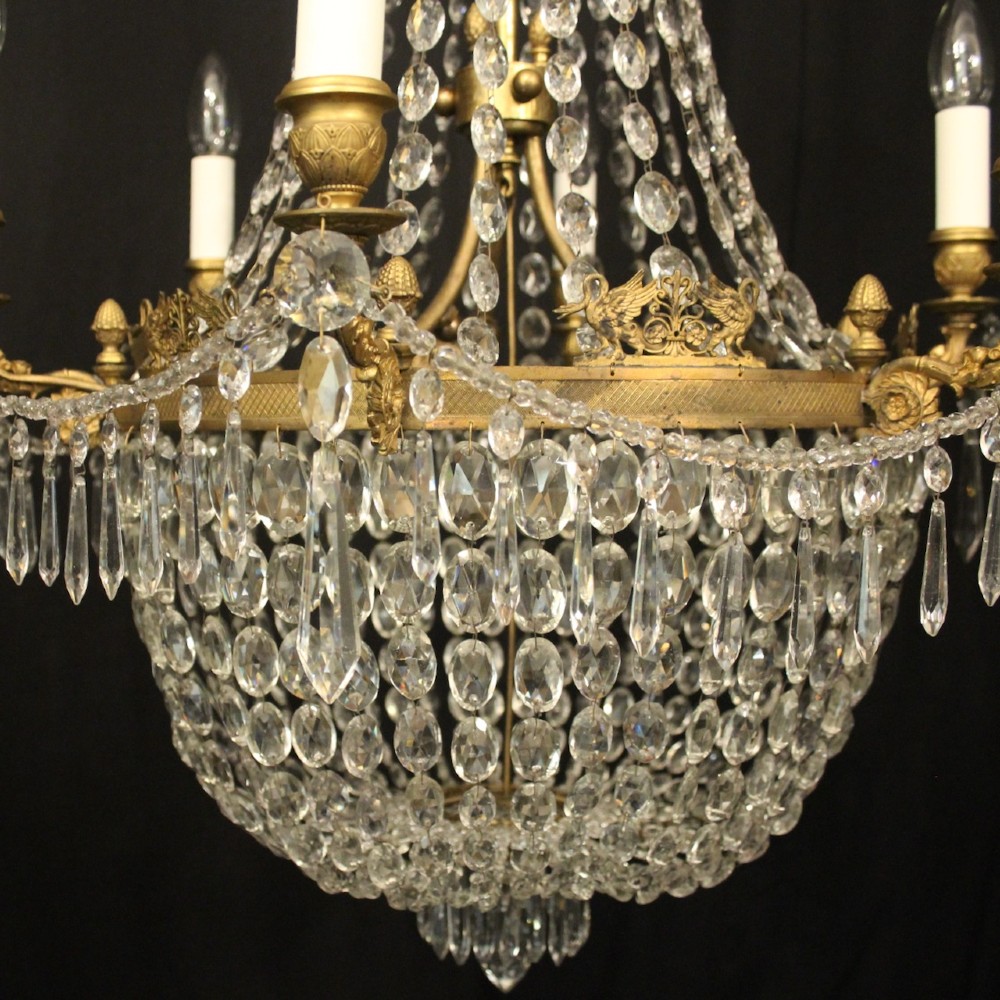 A 19th-century French gilt bronze tent and waterfall chandelier adorned with cascading crystal beads, candle sockets, and hanging glass prisms. View V