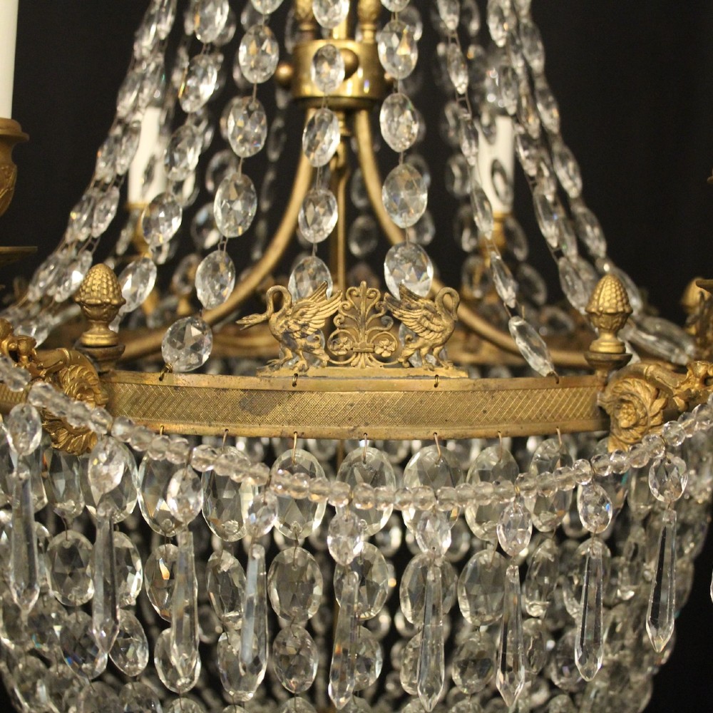 A 19th-century French gilt bronze tent and waterfall chandelier adorned with cascading crystal beads, candle sockets, and hanging glass prisms. View VIII