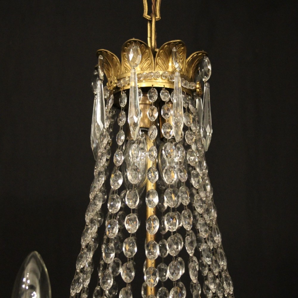 A 19th-century French gilt bronze tent and waterfall chandelier adorned with cascading crystal beads, candle sockets, and hanging glass prisms. View IX