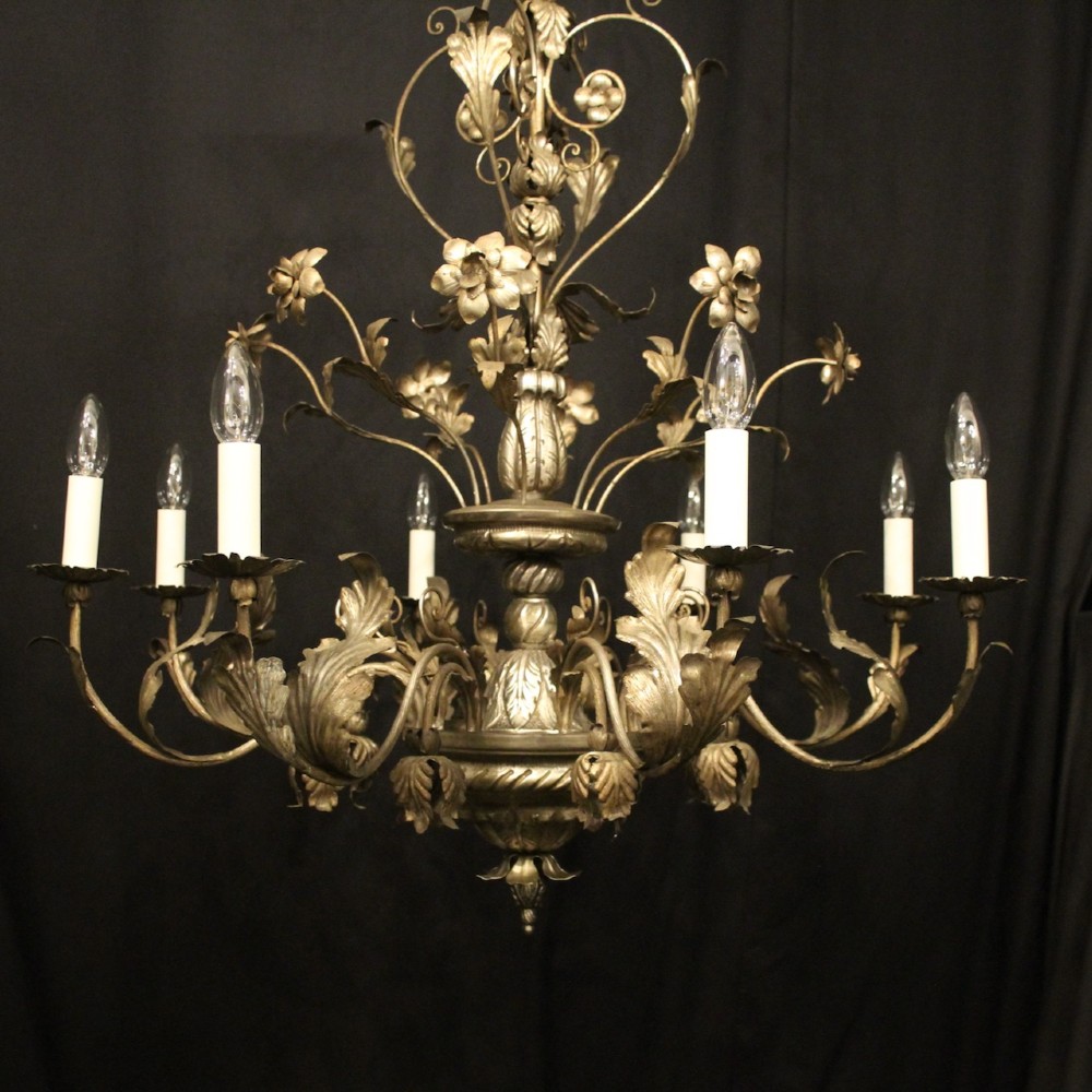 An eight-light Italian silvered gilded metal chandelier featuring elaborate foliate leaves, floral flourishes, and candle-style sockets. View II