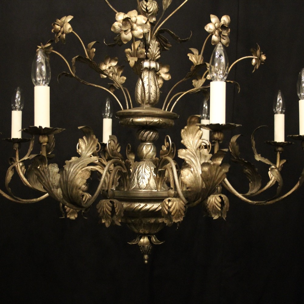 An eight-light Italian silvered gilded metal chandelier featuring elaborate foliate leaves, floral flourishes, and candle-style sockets. View III