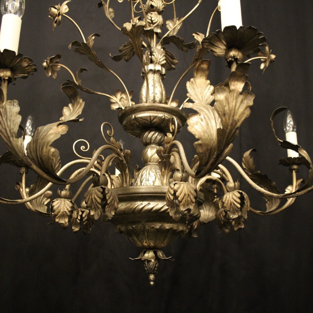 An eight-light Italian silvered gilded metal chandelier featuring elaborate foliate leaves, floral flourishes, and candle-style sockets. View IV