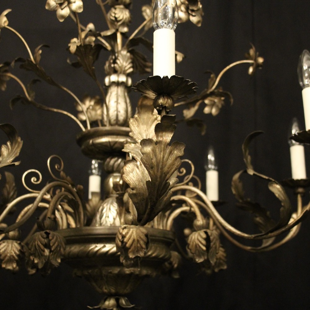 An eight-light Italian silvered gilded metal chandelier featuring elaborate foliate leaves, floral flourishes, and candle-style sockets. View V