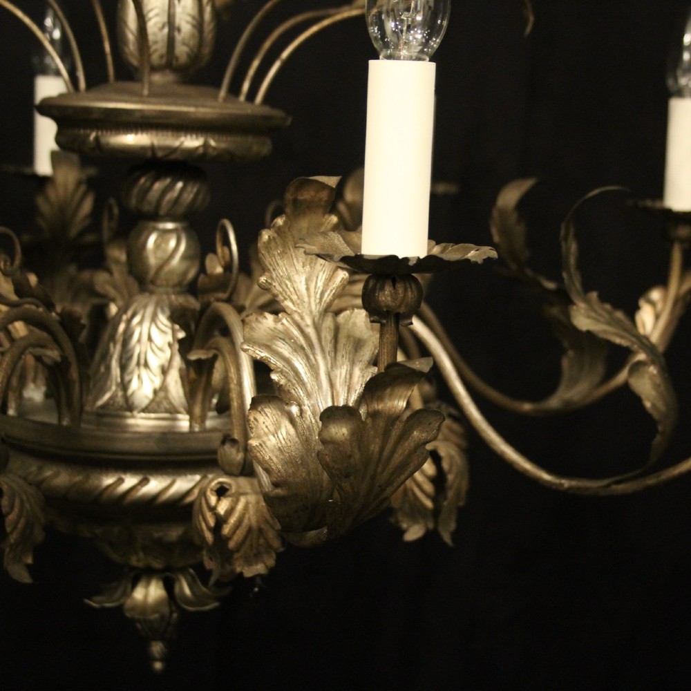 An eight-light Italian silvered gilded metal chandelier featuring elaborate foliate leaves, floral flourishes, and candle-style sockets. View VI