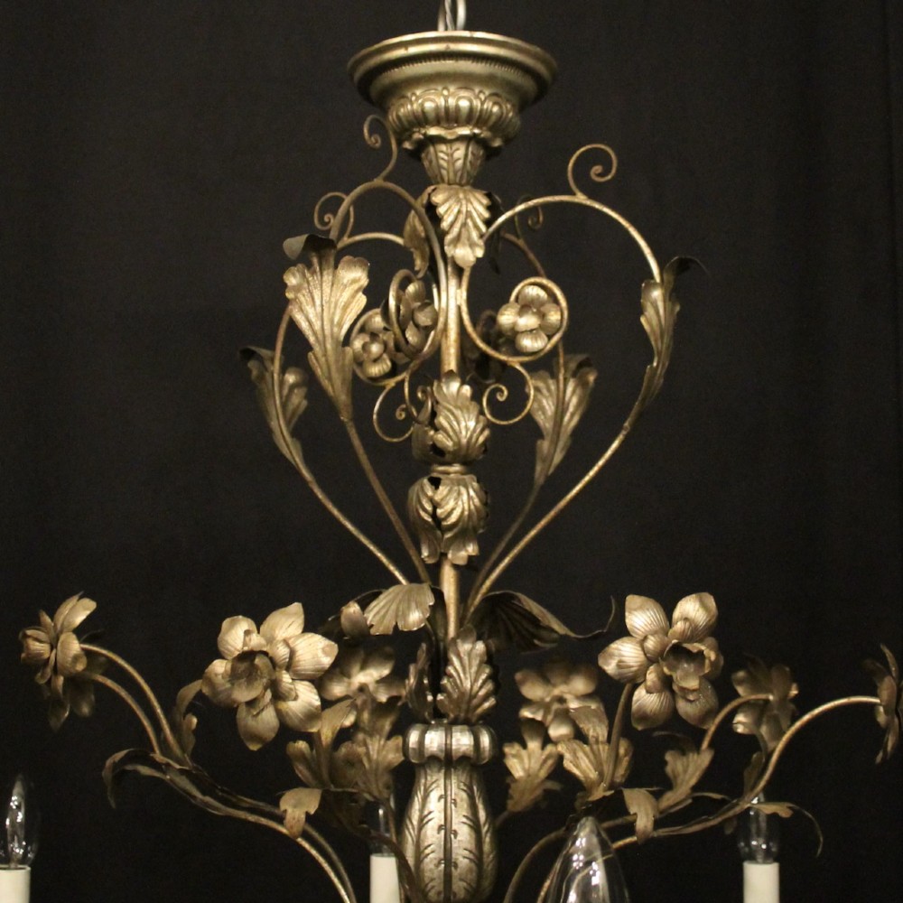 An eight-light Italian silvered gilded metal chandelier featuring elaborate foliate leaves, floral flourishes, and candle-style sockets. View VIII