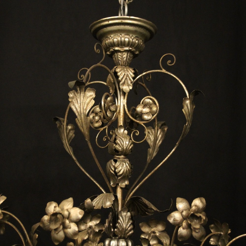 An eight-light Italian silvered gilded metal chandelier featuring elaborate foliate leaves, floral flourishes, and candle-style sockets. View IX