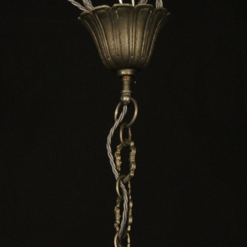 An eight-light Italian silvered gilded metal chandelier featuring elaborate foliate leaves, floral flourishes, and candle-style sockets. View X