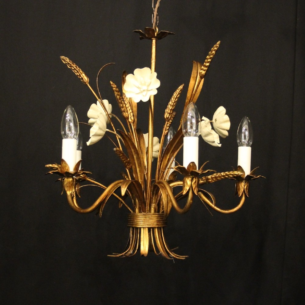 A French five-light gilded metal chandelier featuring a central wheatsheaf motif with cream painted flowers and candle-style bulb sockets.