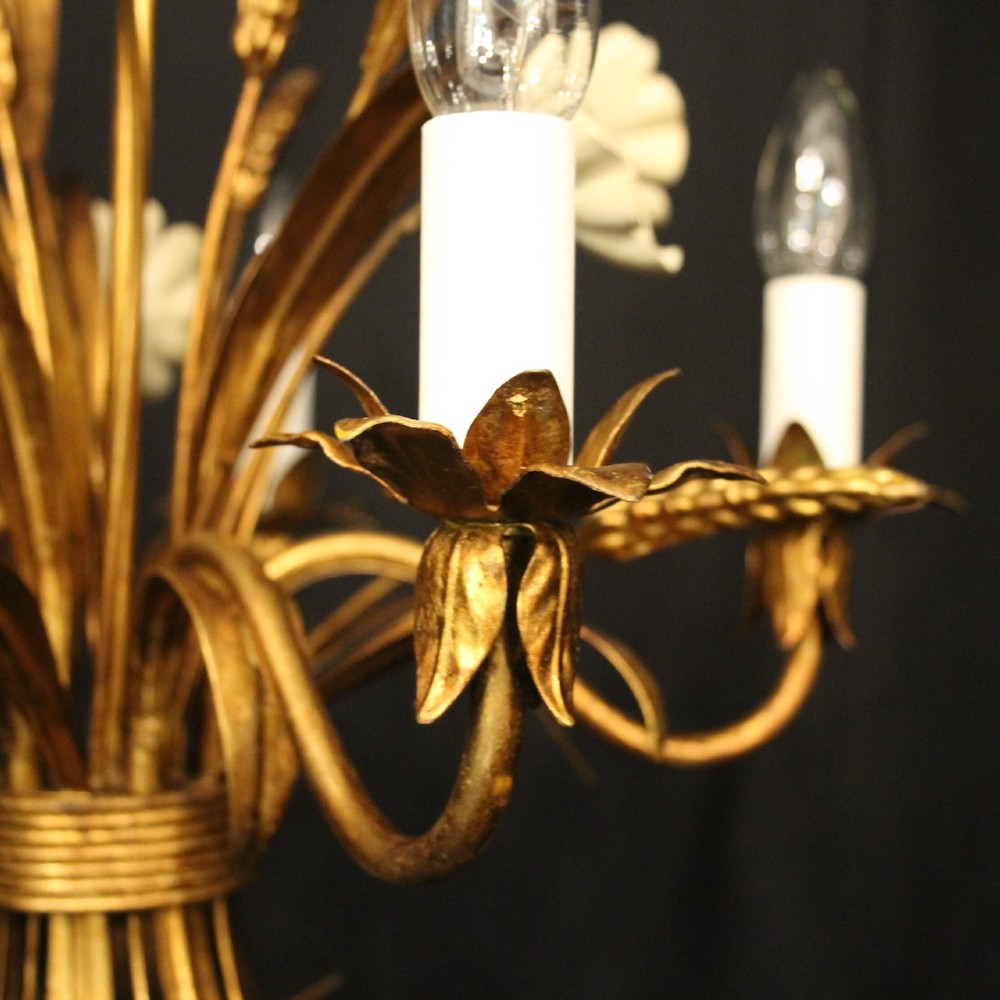 A French five-light gilded metal chandelier featuring a central wheatsheaf motif with cream painted flowers and candle-style bulb sockets. View V