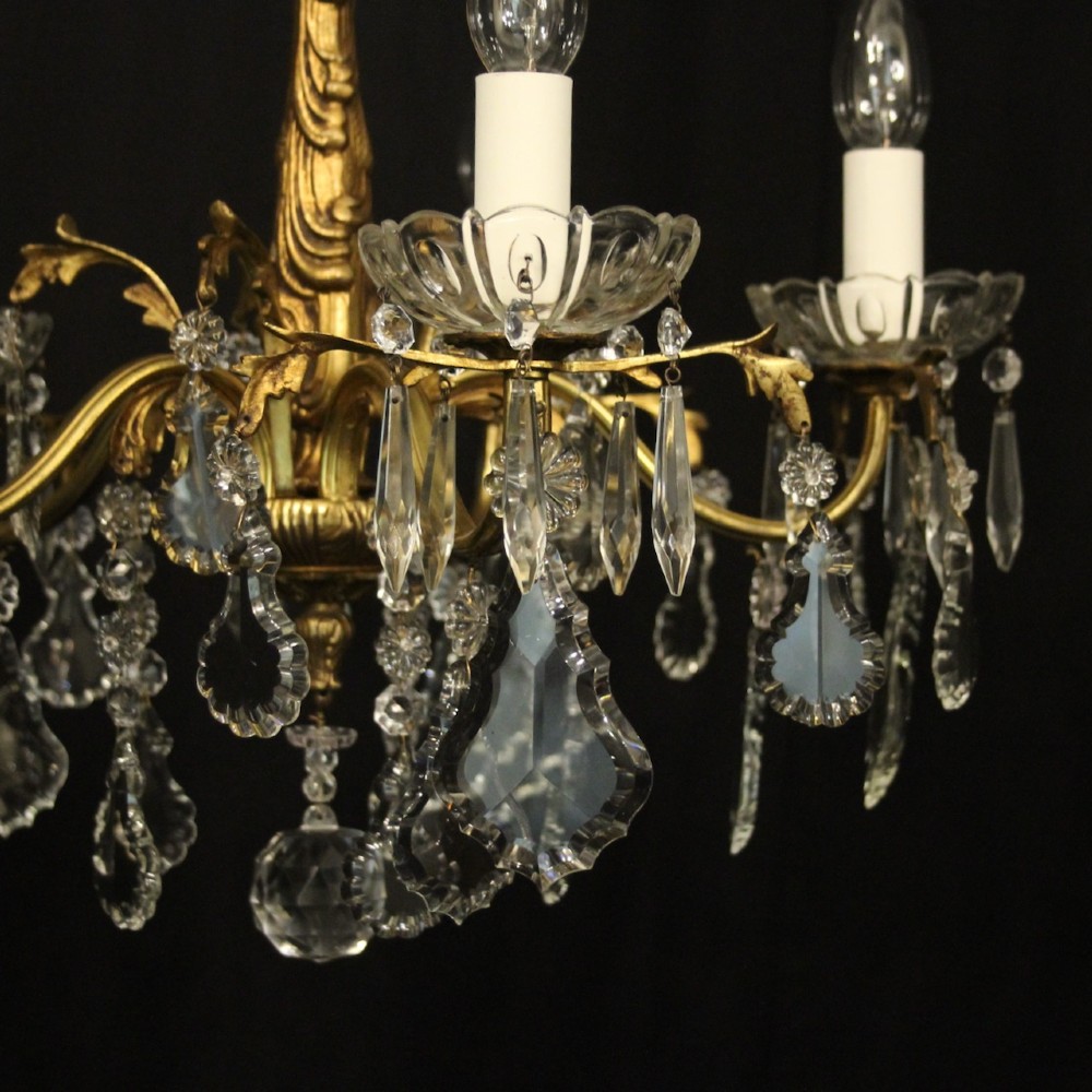 A French gilded metal five-arm chandelier decorated with hanging cut-crystal teardrop pendants and clear glass drip pans. View III