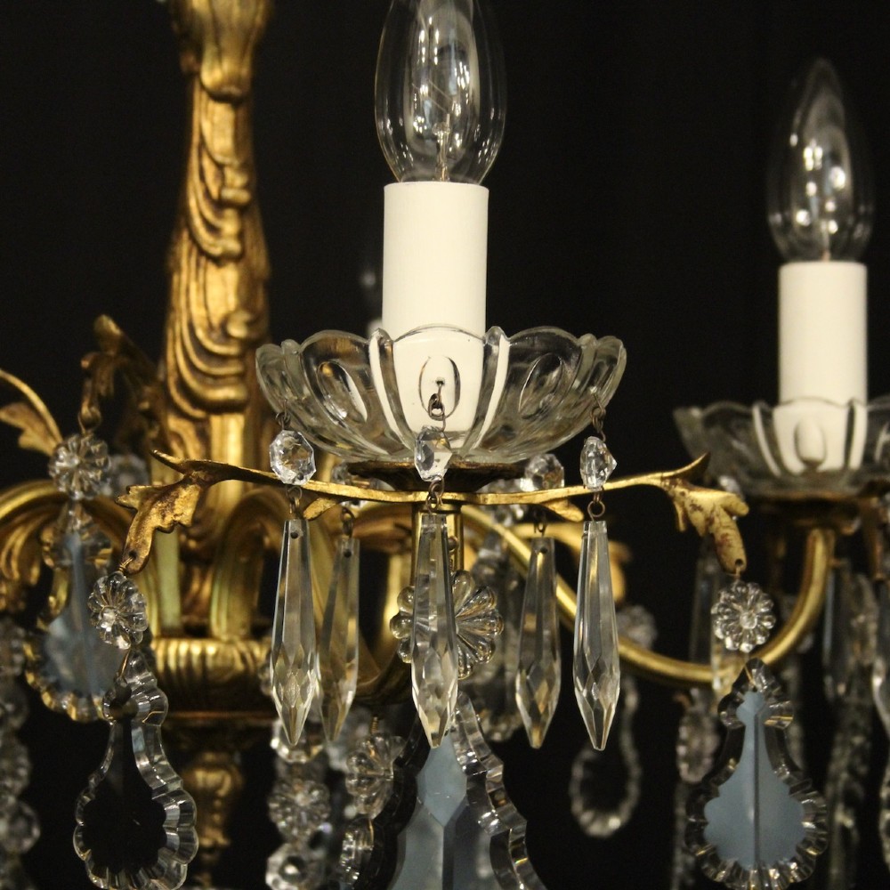 A French gilded metal five-arm chandelier decorated with hanging cut-crystal teardrop pendants and clear glass drip pans. View IV