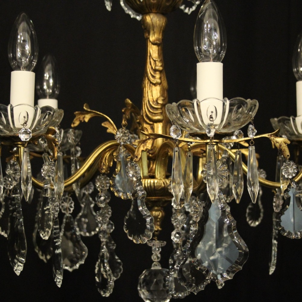A French gilded metal five-arm chandelier decorated with hanging cut-crystal teardrop pendants and clear glass drip pans. View V