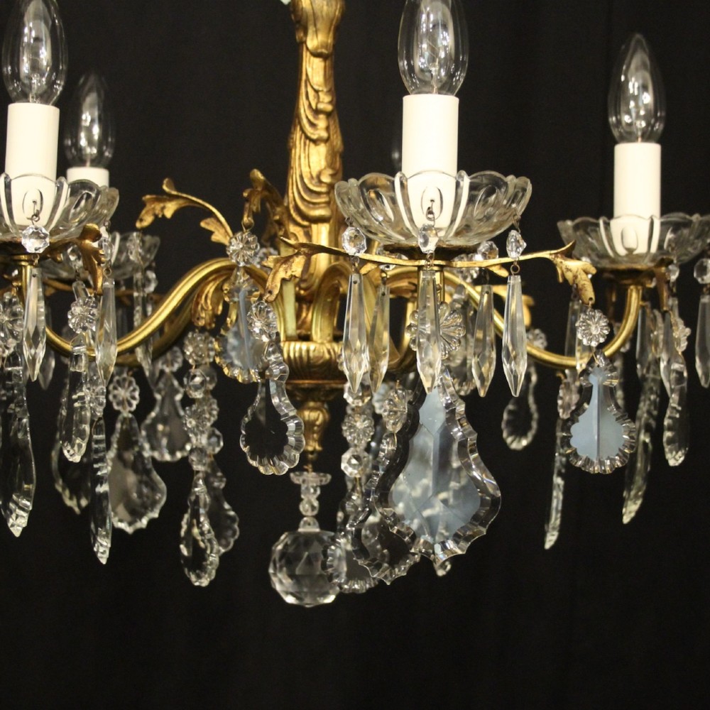 A French gilded metal five-arm chandelier decorated with hanging cut-crystal teardrop pendants and clear glass drip pans. View VI