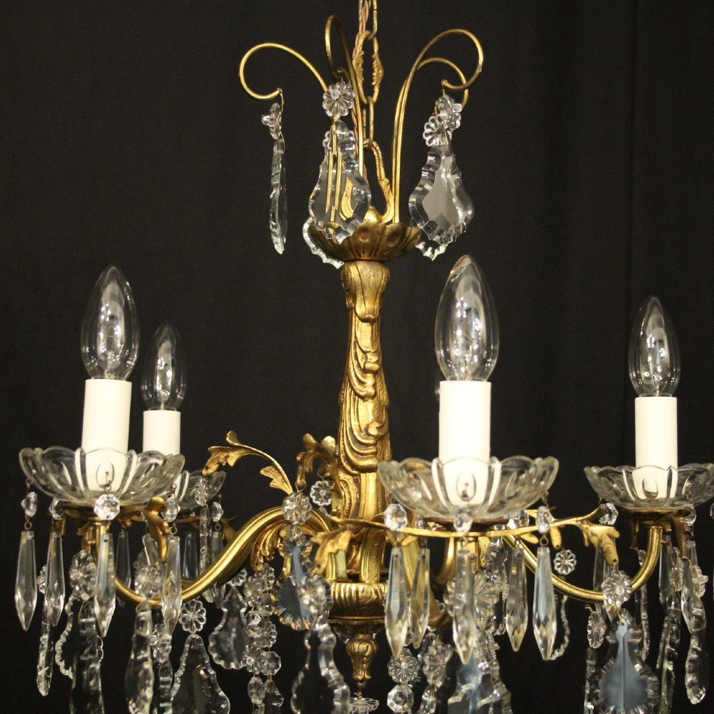 A French gilded metal five-arm chandelier decorated with hanging cut-crystal teardrop pendants and clear glass drip pans. View VII