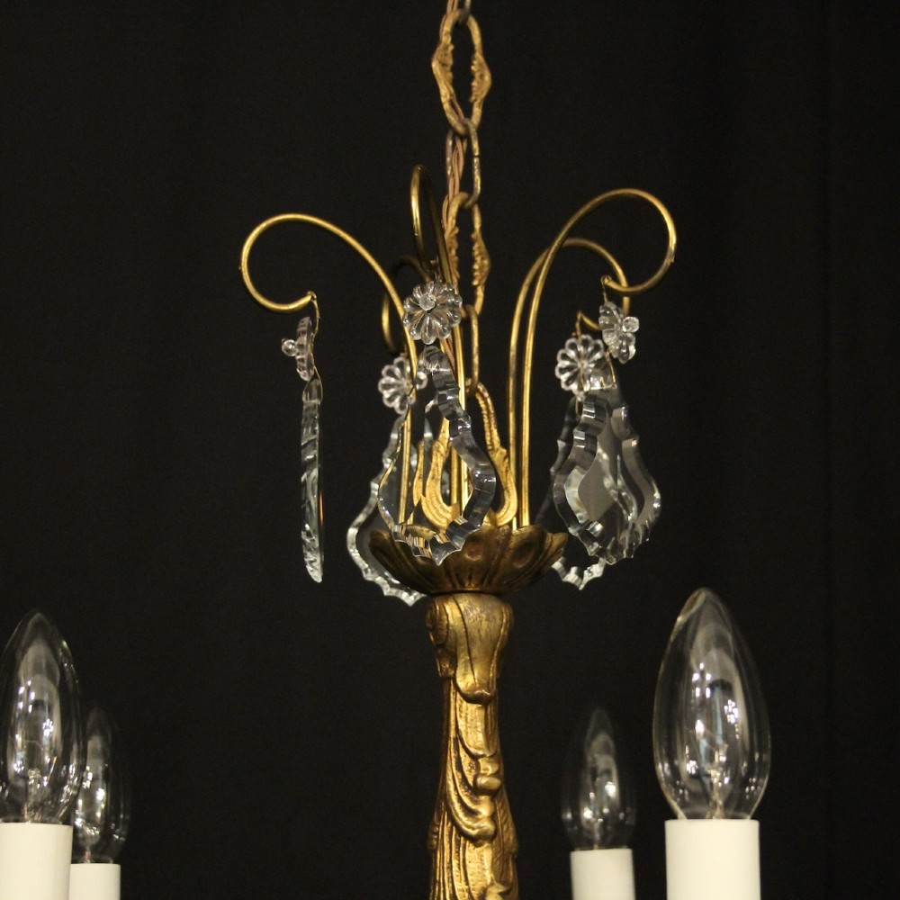 A French gilded metal five-arm chandelier decorated with hanging cut-crystal teardrop pendants and clear glass drip pans. View VIII