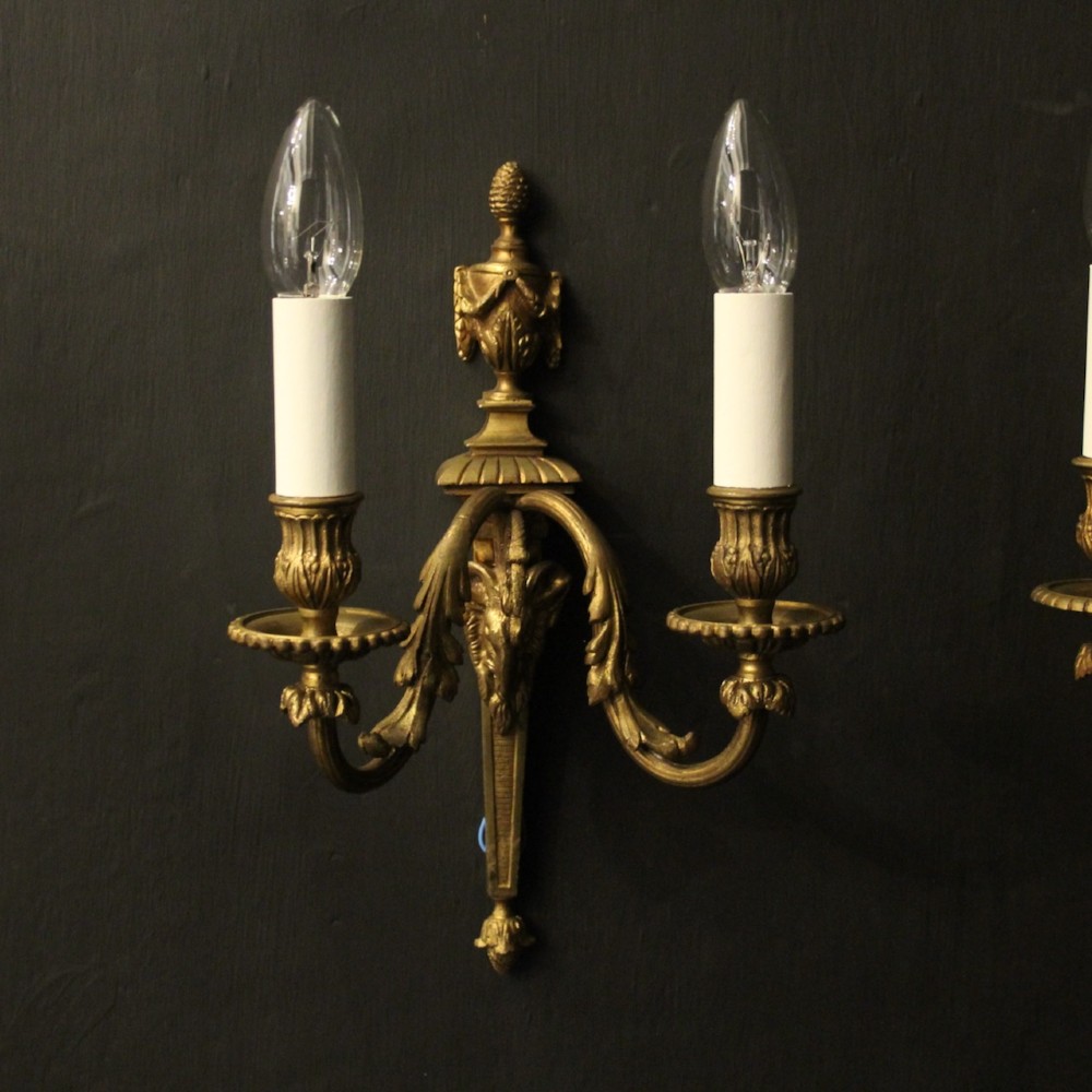 A pair of antique gilded bronze two-arm wall lights decorated with central urn finials and acanthus leaf scroll branches. View II