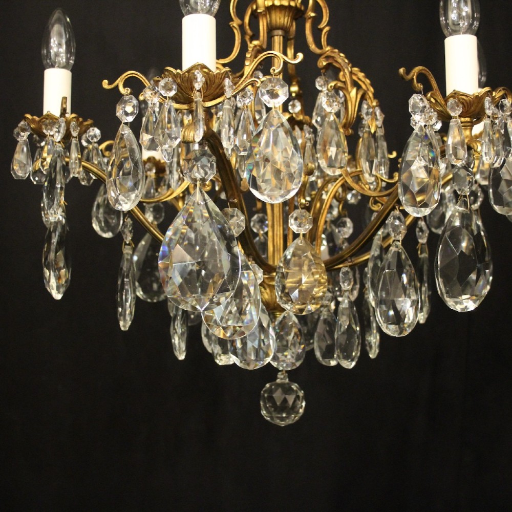 A six-light French gilded metal chandelier decorated with faceted crystal drops and hanging glass pendants. View III