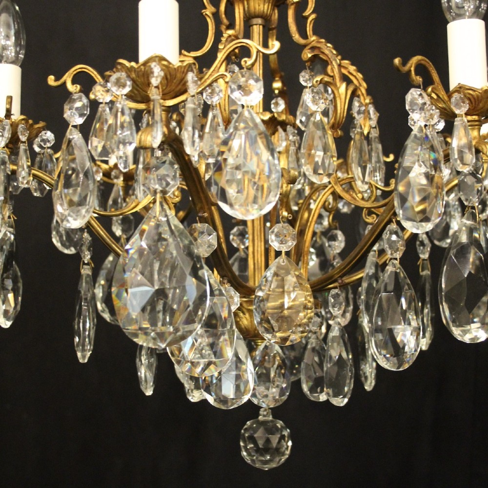A six-light French gilded metal chandelier decorated with faceted crystal drops and hanging glass pendants. View V