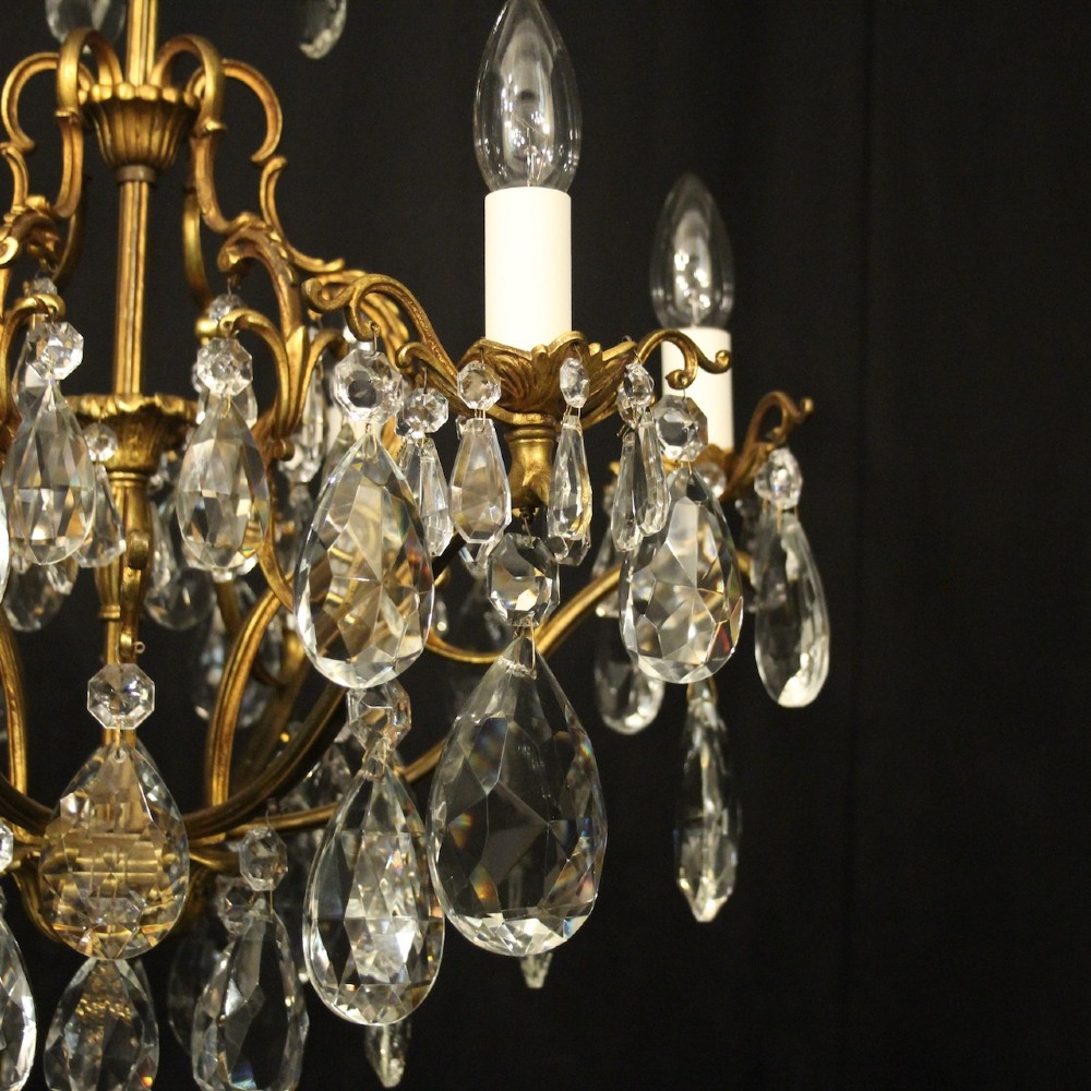 A six-light French gilded metal chandelier decorated with faceted crystal drops and hanging glass pendants. View VI