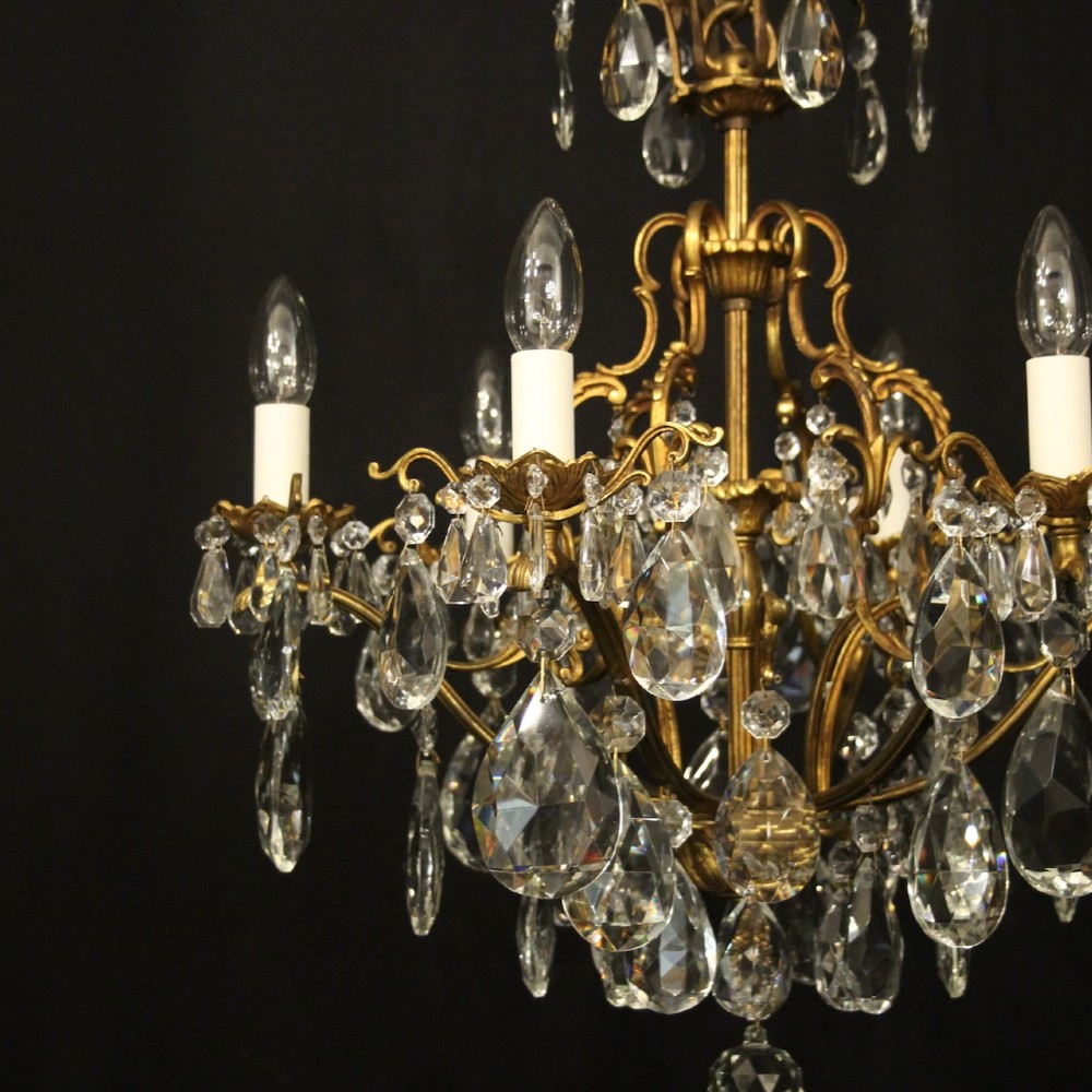 A six-light French gilded metal chandelier decorated with faceted crystal drops and hanging glass pendants. View VII