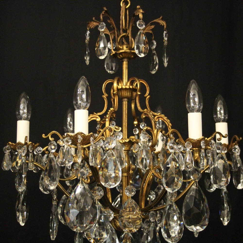A six-light French gilded metal chandelier decorated with faceted crystal drops and hanging glass pendants. View VIII