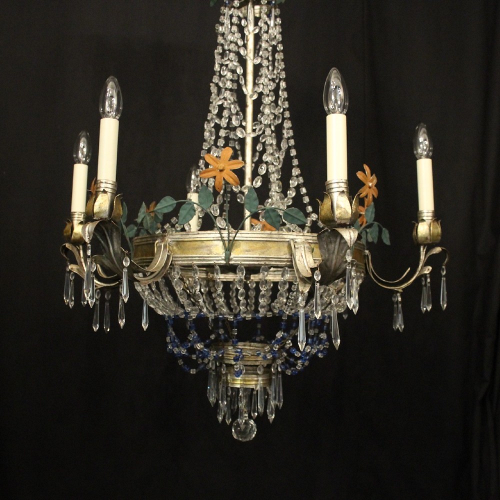 A French tent and waterfall chandelier featuring a silver-gilded frame with floral accents, layered crystal bead strands, glass drops, and six candle light sockets. View VII