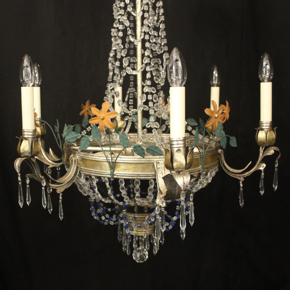 A French tent and waterfall chandelier featuring a silver-gilded frame with floral accents, layered crystal bead strands, glass drops, and six candle light sockets. View VIII