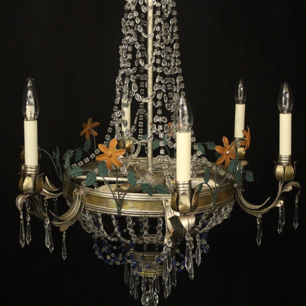 A French tent and waterfall chandelier featuring a silver-gilded frame with floral accents, layered crystal bead strands, glass drops, and six candle light sockets. View IX