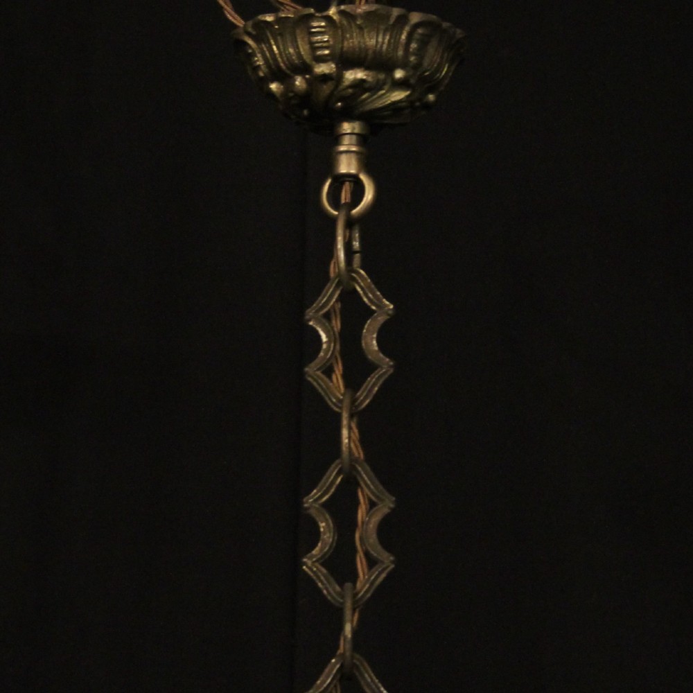 A pair of antique French eight-light brass chandeliers featuring scrolled arms and cut crystal teardrop prisms. View X