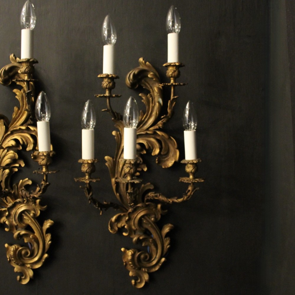 A pair of ornate French Rococo style gilded bronze five-arm wall sconces featuring acanthus leaf scrollwork. View II