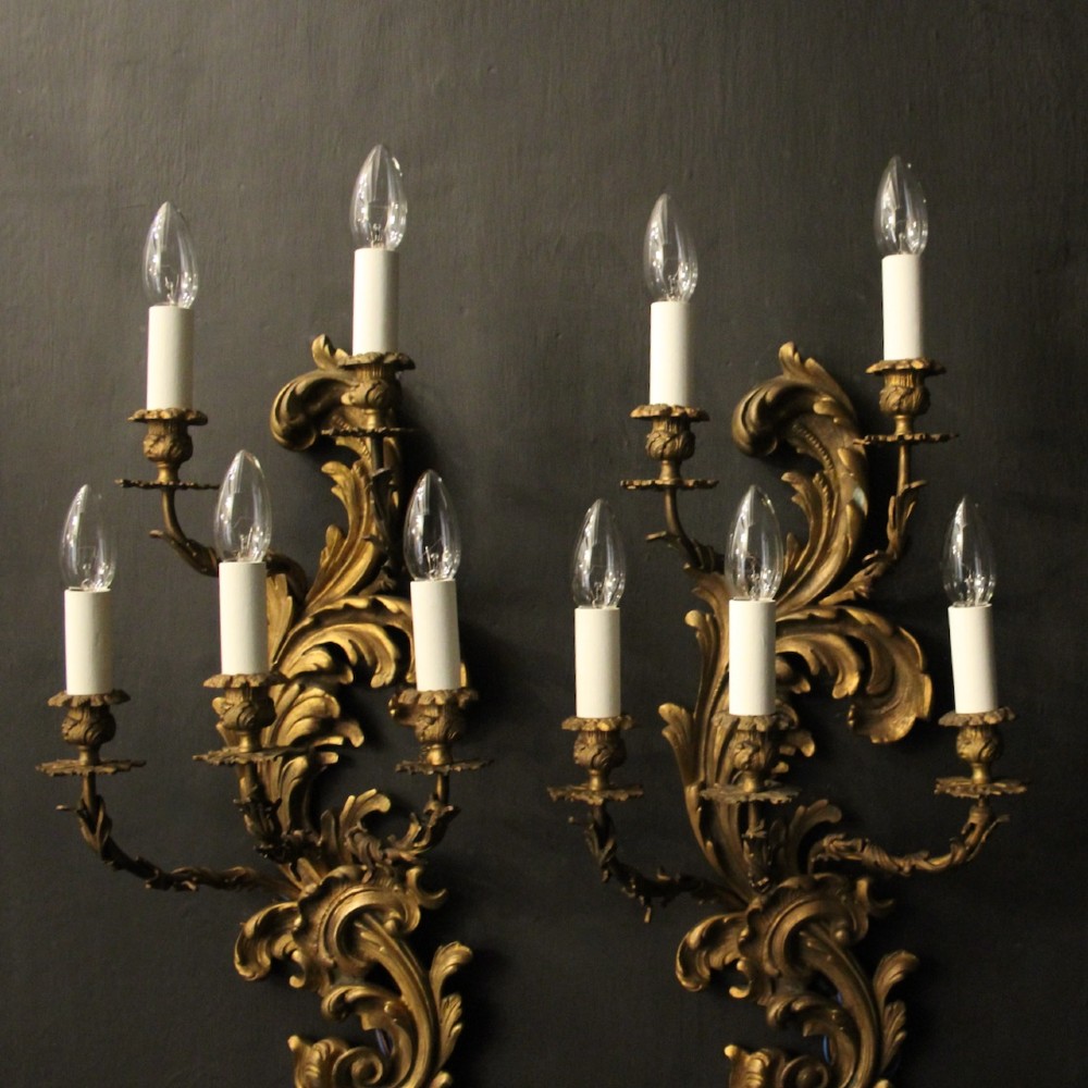 A pair of ornate French Rococo style gilded bronze five-arm wall sconces featuring acanthus leaf scrollwork. View III