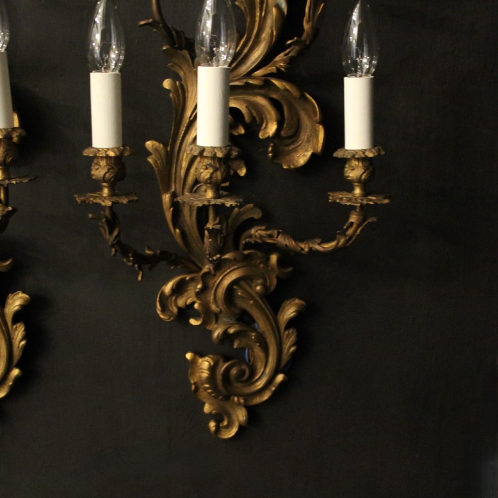 A pair of ornate French Rococo style gilded bronze five-arm wall sconces featuring acanthus leaf scrollwork. View VI