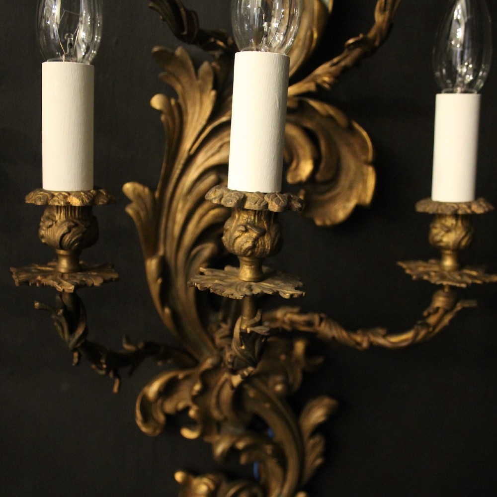 A pair of ornate French Rococo style gilded bronze five-arm wall sconces featuring acanthus leaf scrollwork. View VII