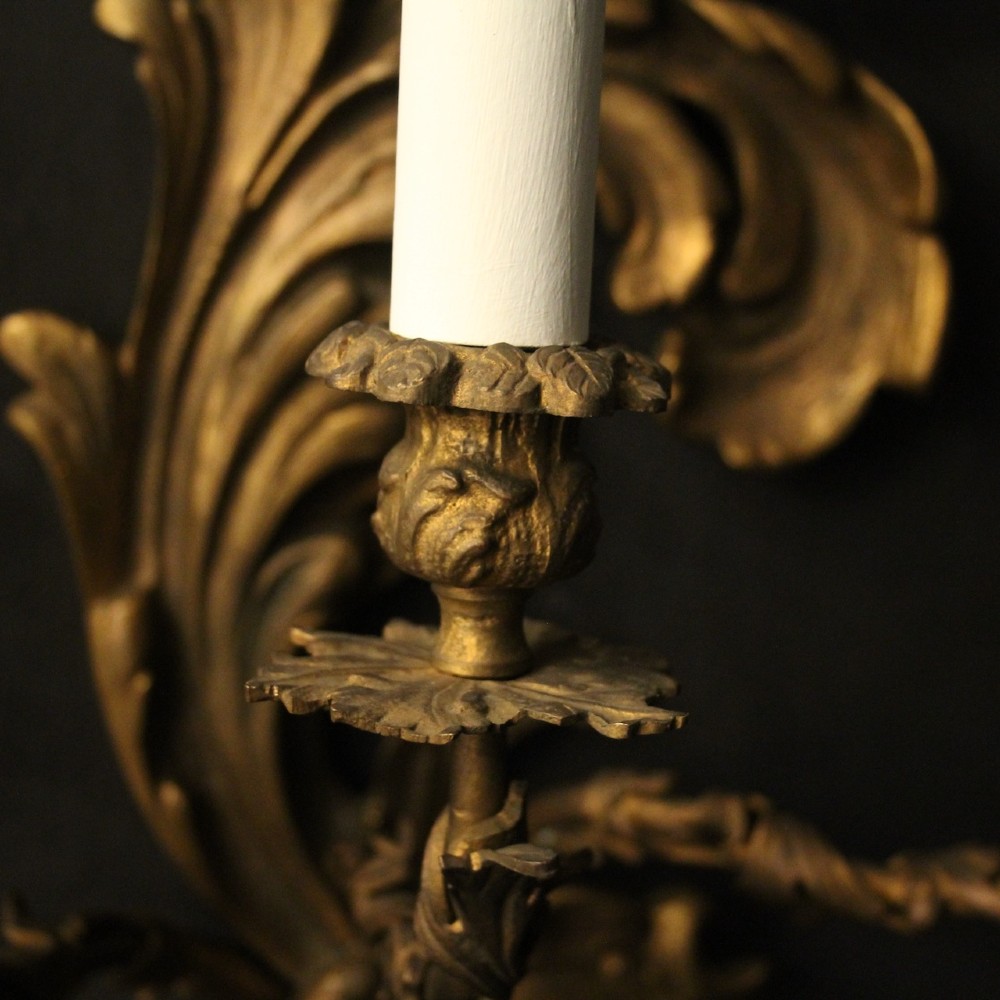 A pair of ornate French Rococo style gilded bronze five-arm wall sconces featuring acanthus leaf scrollwork. View VIII