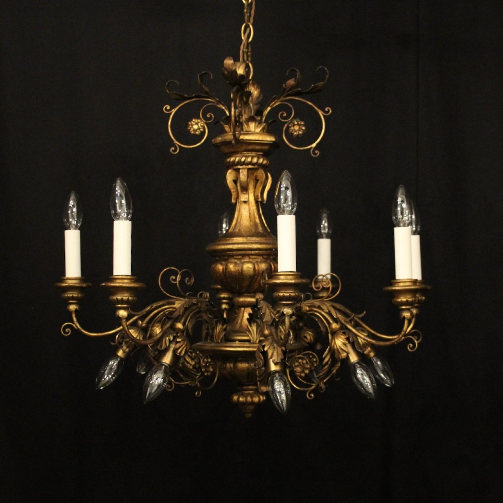 A multi-arm Florentine carved giltwood chandelier featuring leaf scroll detailing and candle sockets.