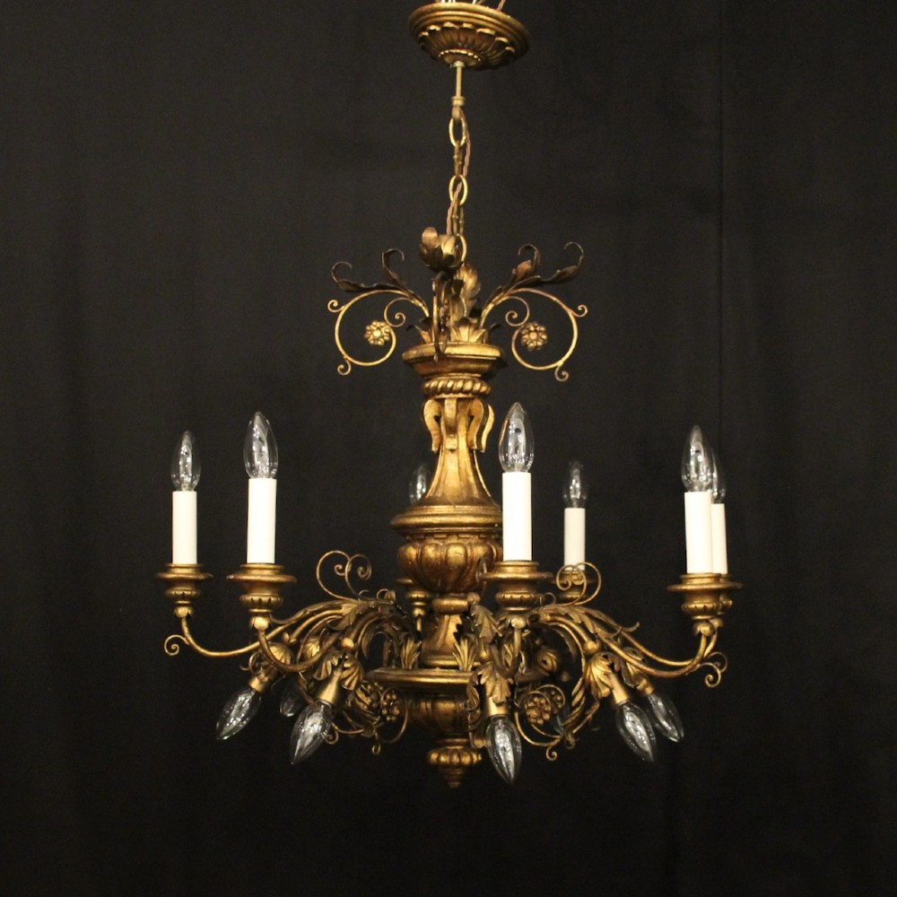 A multi-arm Florentine carved giltwood chandelier featuring leaf scroll detailing and candle sockets. View II