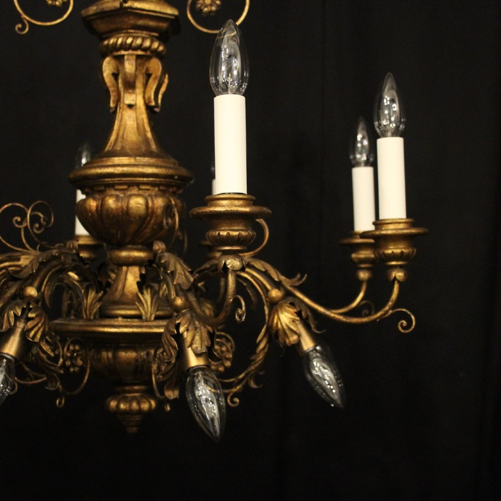 A multi-arm Florentine carved giltwood chandelier featuring leaf scroll detailing and candle sockets. View III