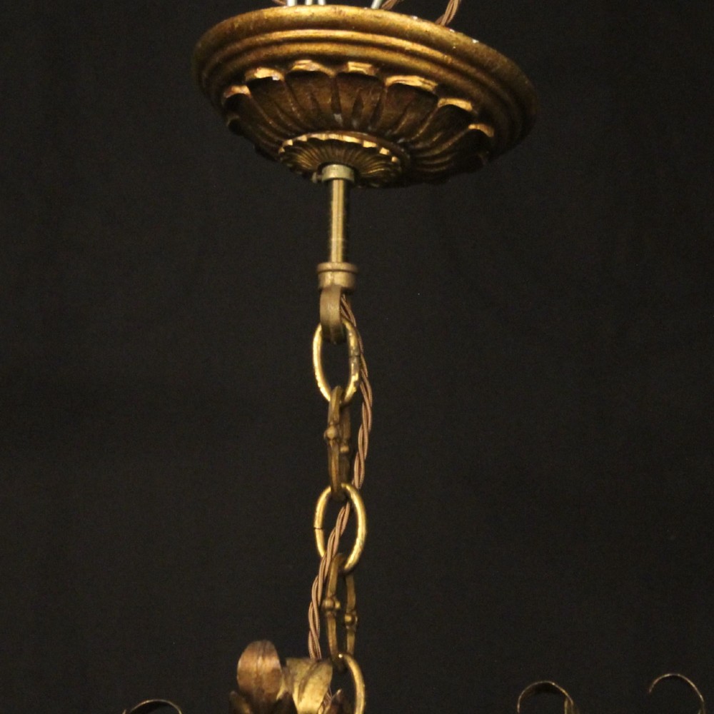 A multi-arm Florentine carved giltwood chandelier featuring leaf scroll detailing and candle sockets. View X