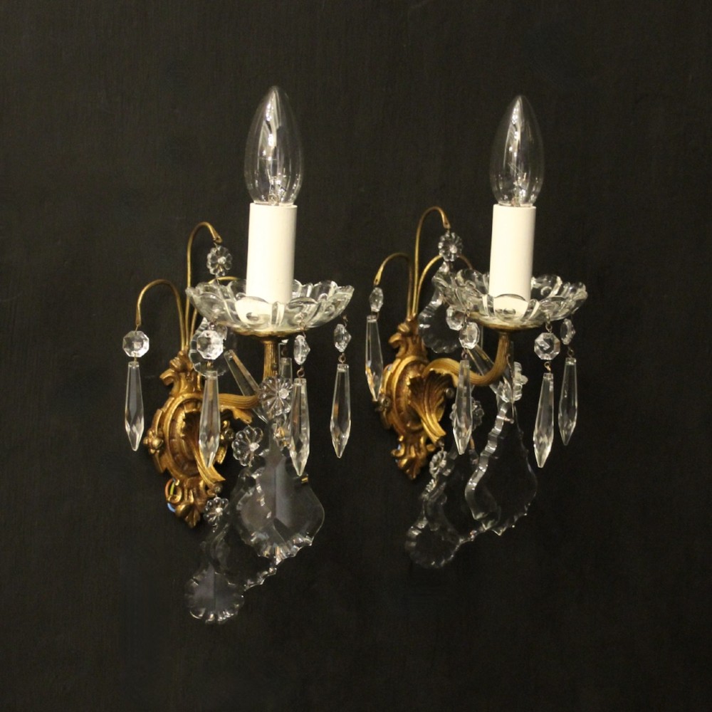 A pair of French gilded single-arm wall lights featuring clear crystal drops and scalloped glass drip pans. View II