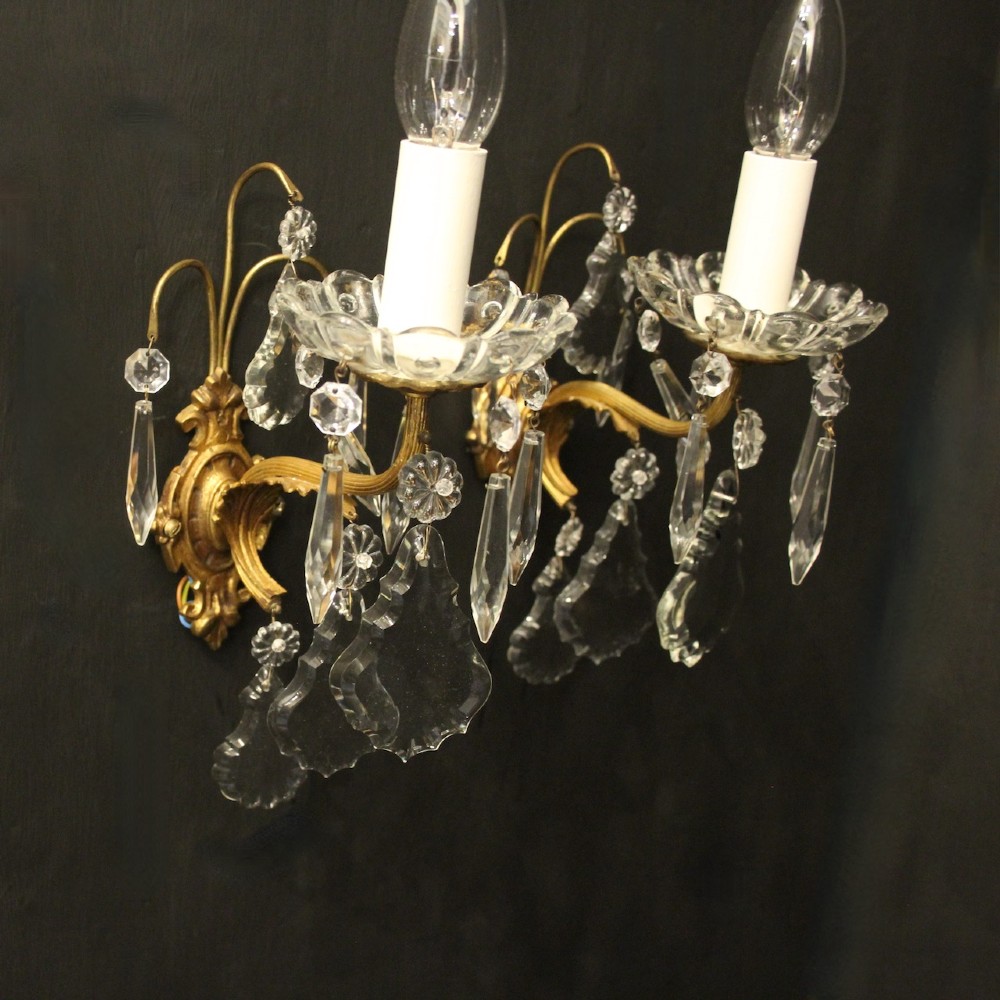 A pair of French gilded single-arm wall lights featuring clear crystal drops and scalloped glass drip pans. View III