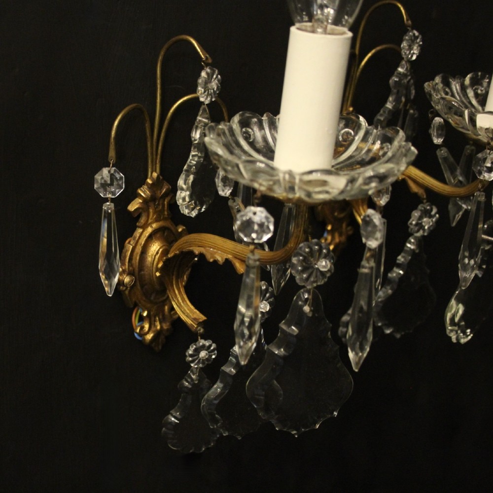 A pair of French gilded single-arm wall lights featuring clear crystal drops and scalloped glass drip pans. View VI